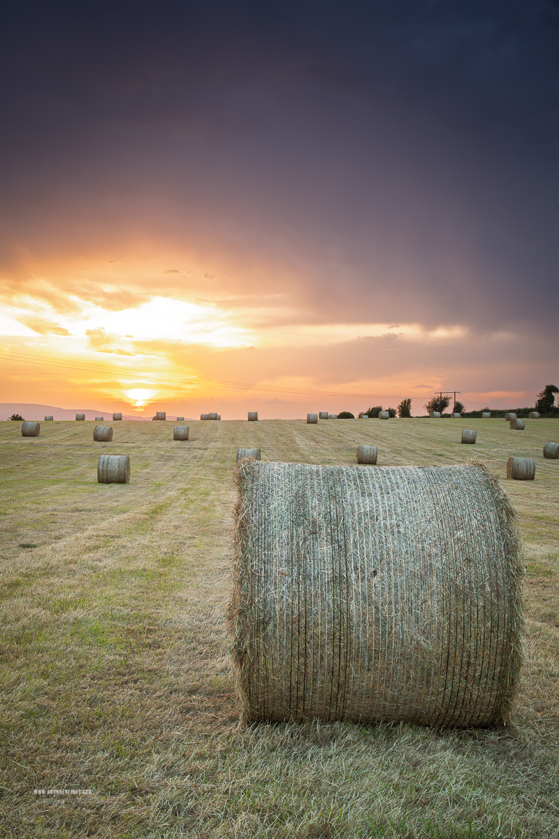 Close view of a hay bale against glowing sunset skies in rural County Galway.